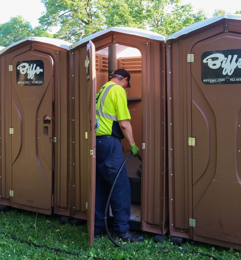 Portable Restroom Servicing | Biff’s Biff's service technician cleaning and servicing a portable restroom on site to ensure a clean, sanitized, and fully stocked unit.